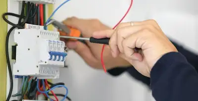 Electrician installing and adjusting circuit breakers in an electrical panel in Clearwater, FL