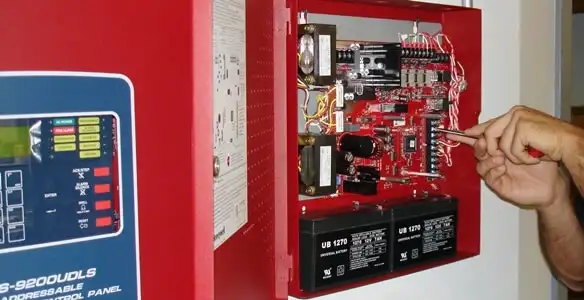 fire alarm installation service showing technician configuring fire alarm control panel in Clearwater, FL