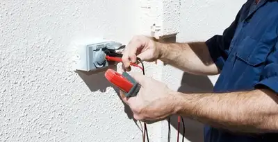Electrician performing home electrical outlet and wiring inspection in Clearwater, FL