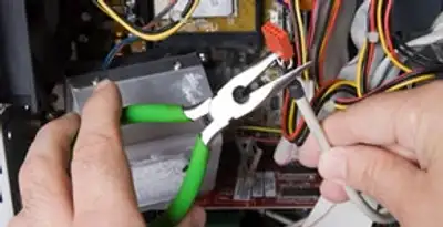 Licensed electrical contractor performing electrical repair with tools in Seminole, FL