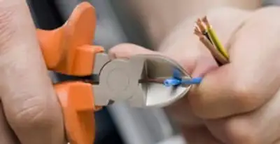 professional electrical services showing precise wire cutting by licensed electricians in Clearwater, FL