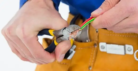 licensed electrician securing electrical wiring with professional tools during service work in Clearwater, FL
