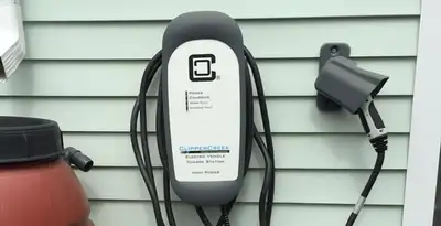 Outdoor electric vehicle charger installation on residential wall in Clearwater, FL